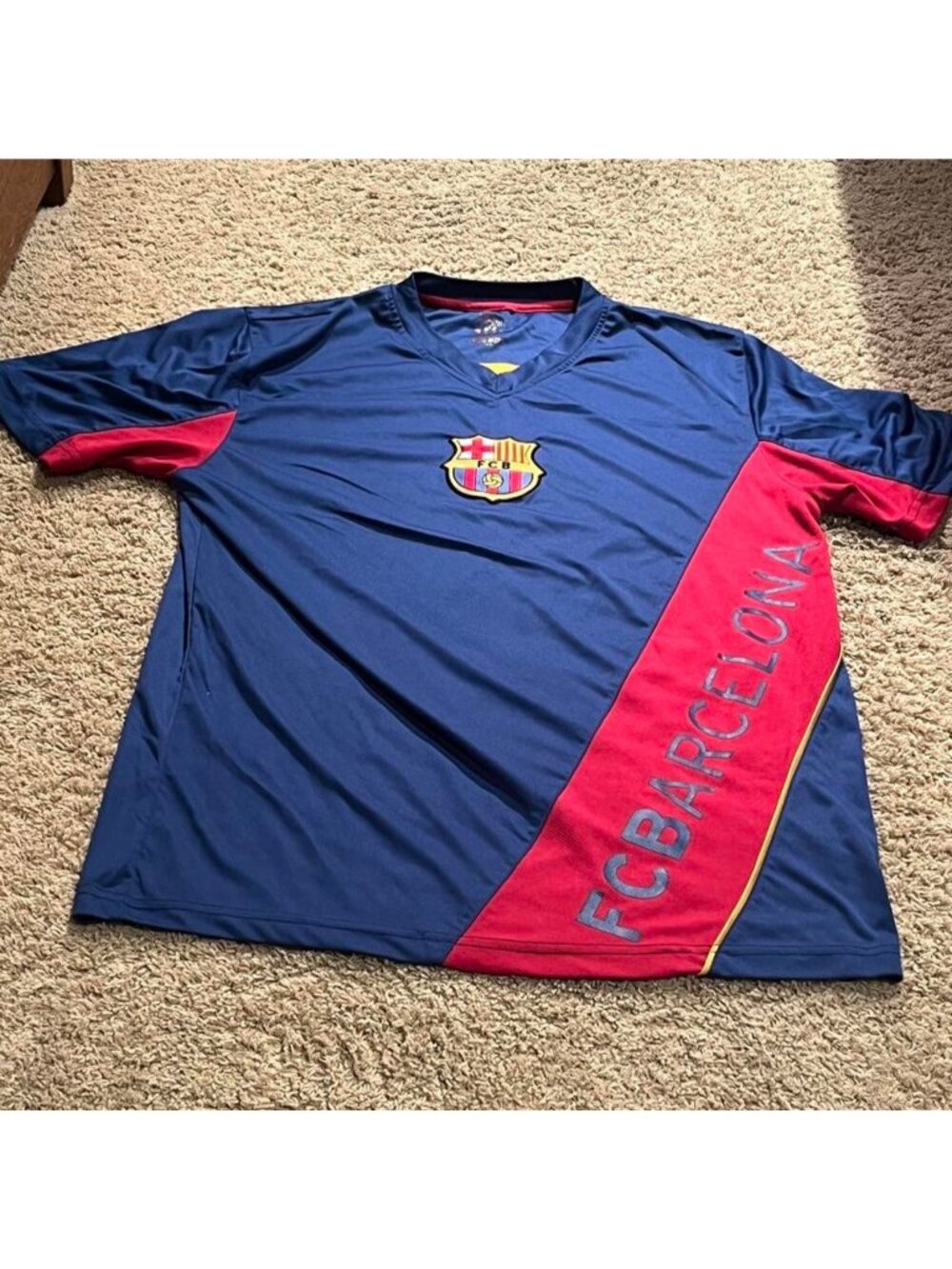 FC Barcelona blue jersey with red diagonal stripe and 'FC BARCELONA' text